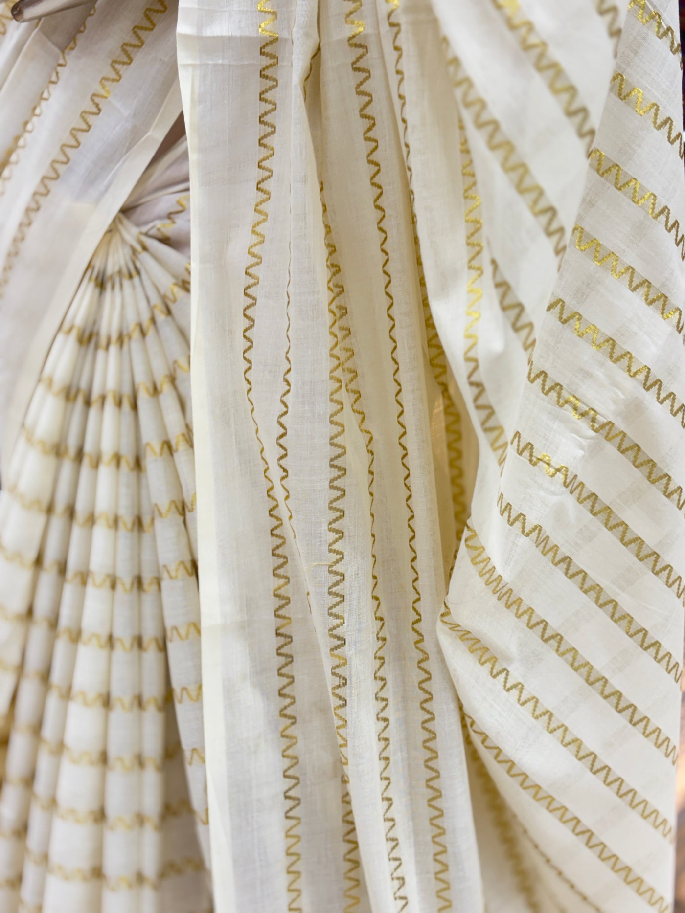 Off-White Cotton Borderless | Set Kerala Kasavu Saree | Zig-Zag Gold Stripes | with Black Tassels on Pallu